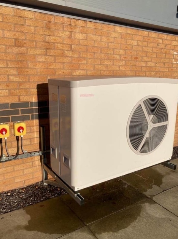 An air source heat pump mounted on a wall